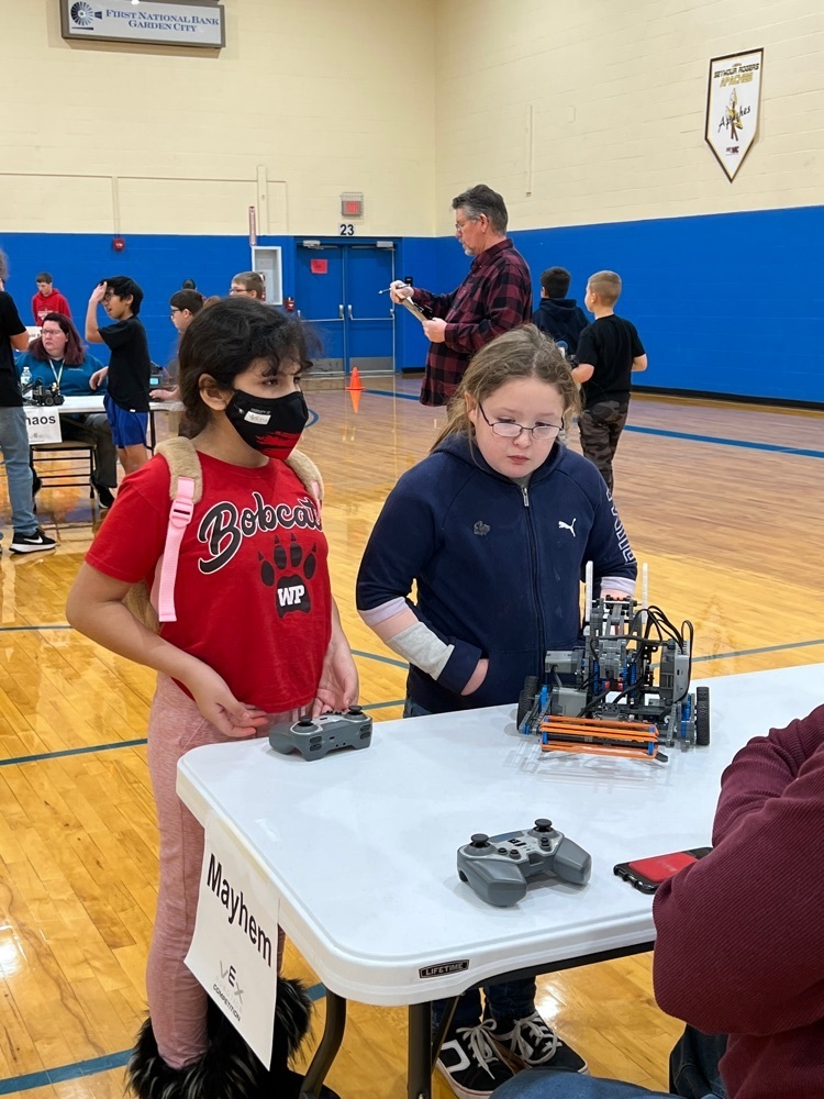 students check in their robot before their team challenge match.