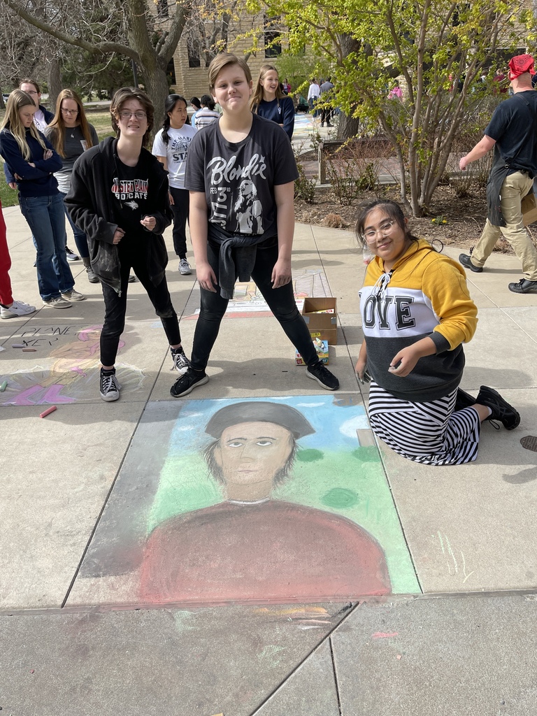 Students pose with their sidewalk chalk entry