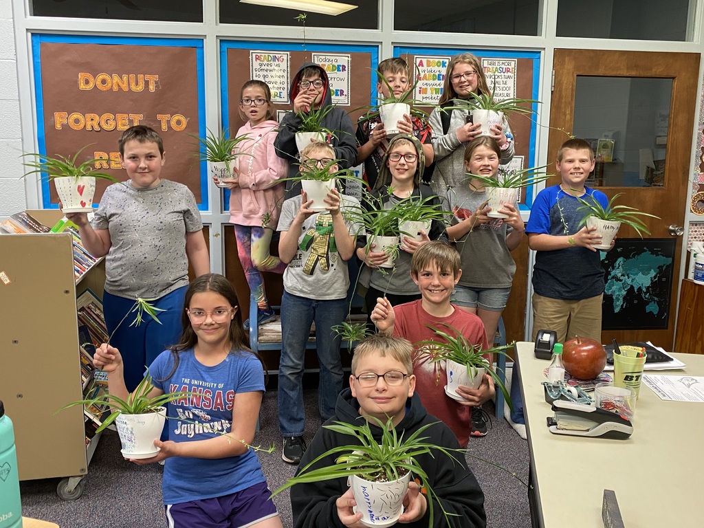 students holding plants