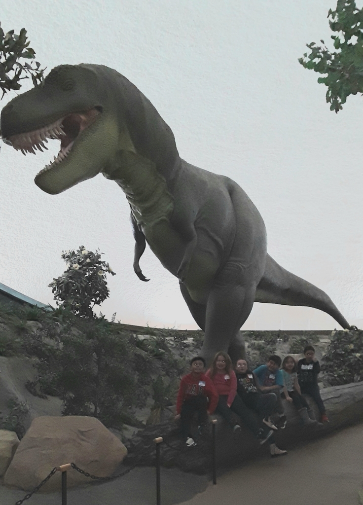 Students under a moving, roaring T-Rex