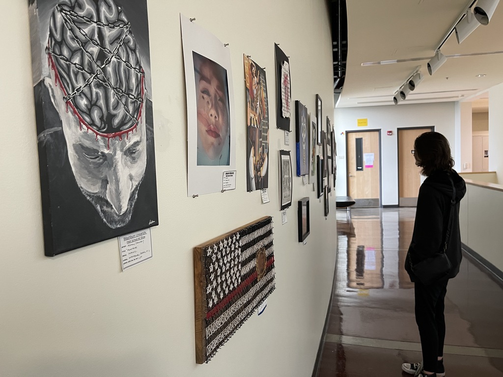 Student Views the artwork on the wall